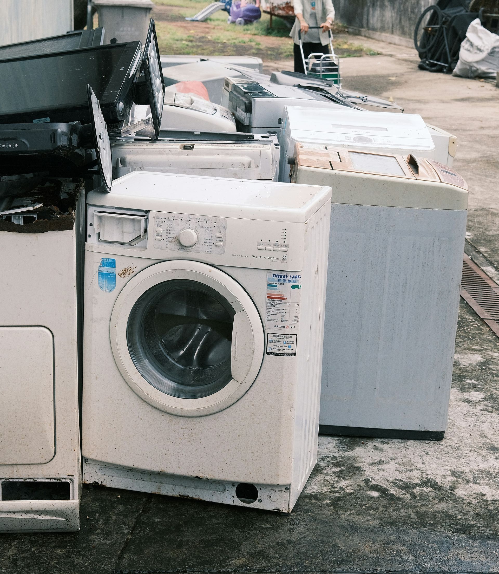 a pile of washing machines sitting next to each other
